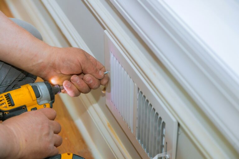 Maintenance repair, man is making the wall vent cover indoor central air conditioning, vents